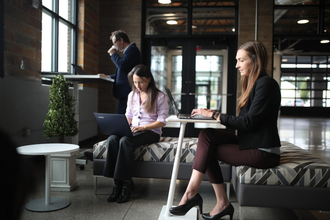 team collaborating on laptops securely sharing files
